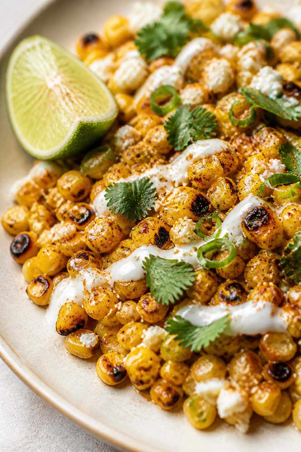Close-up detail: Charred street corn kernels tossed with smoked paprika, chili powder, and a squeeze