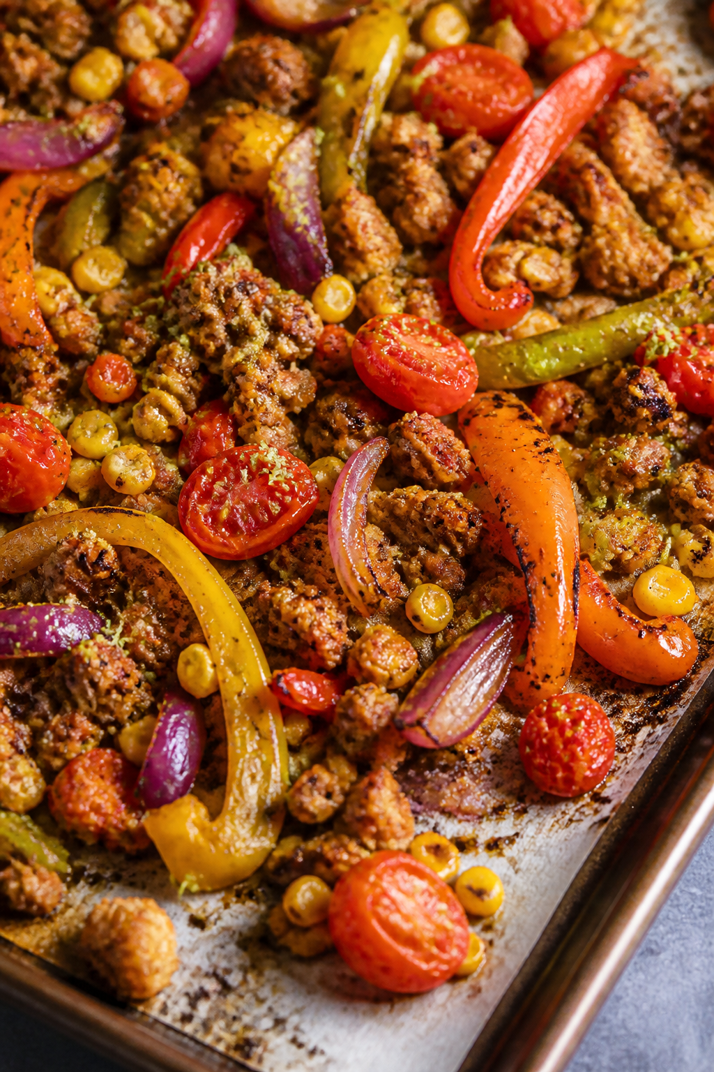Close-up detail: Roasted sheet pan taco components just out of the oven—charred bell pepper strips