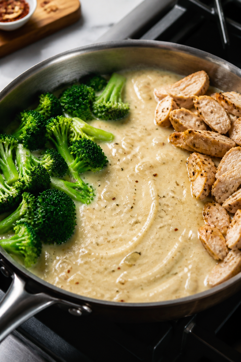 Cooking process: Making the sauce in-skillet—cream cheese cubes just melted smooth into chicken br