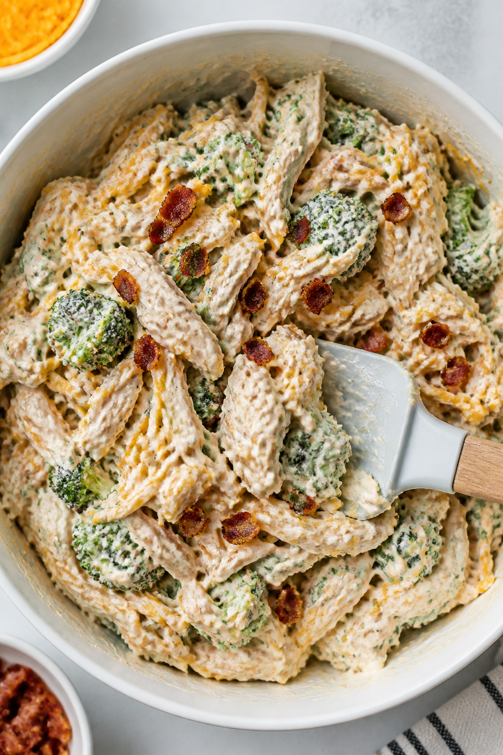 Cooking process: Overhead shot of the creamy ranch-cheese mixture being folded with shredded chicken