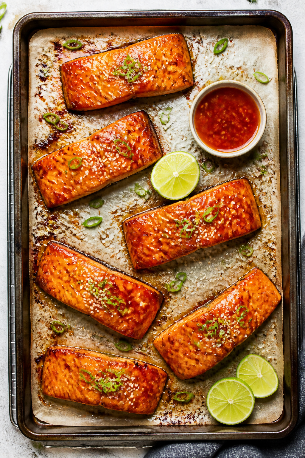 Overhead “tasty top view”: Entire sheet pan of cooked salmon fillets arranged with space between