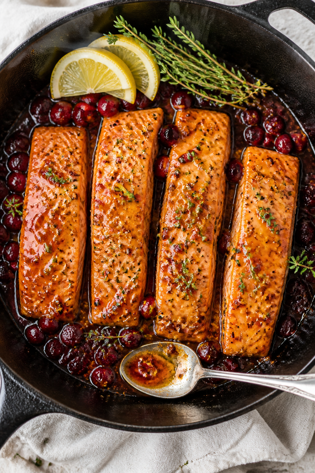 Overhead tasty top view: One-pan Cranberry Maple Salmon just out of the oven in a black cast-iron sk