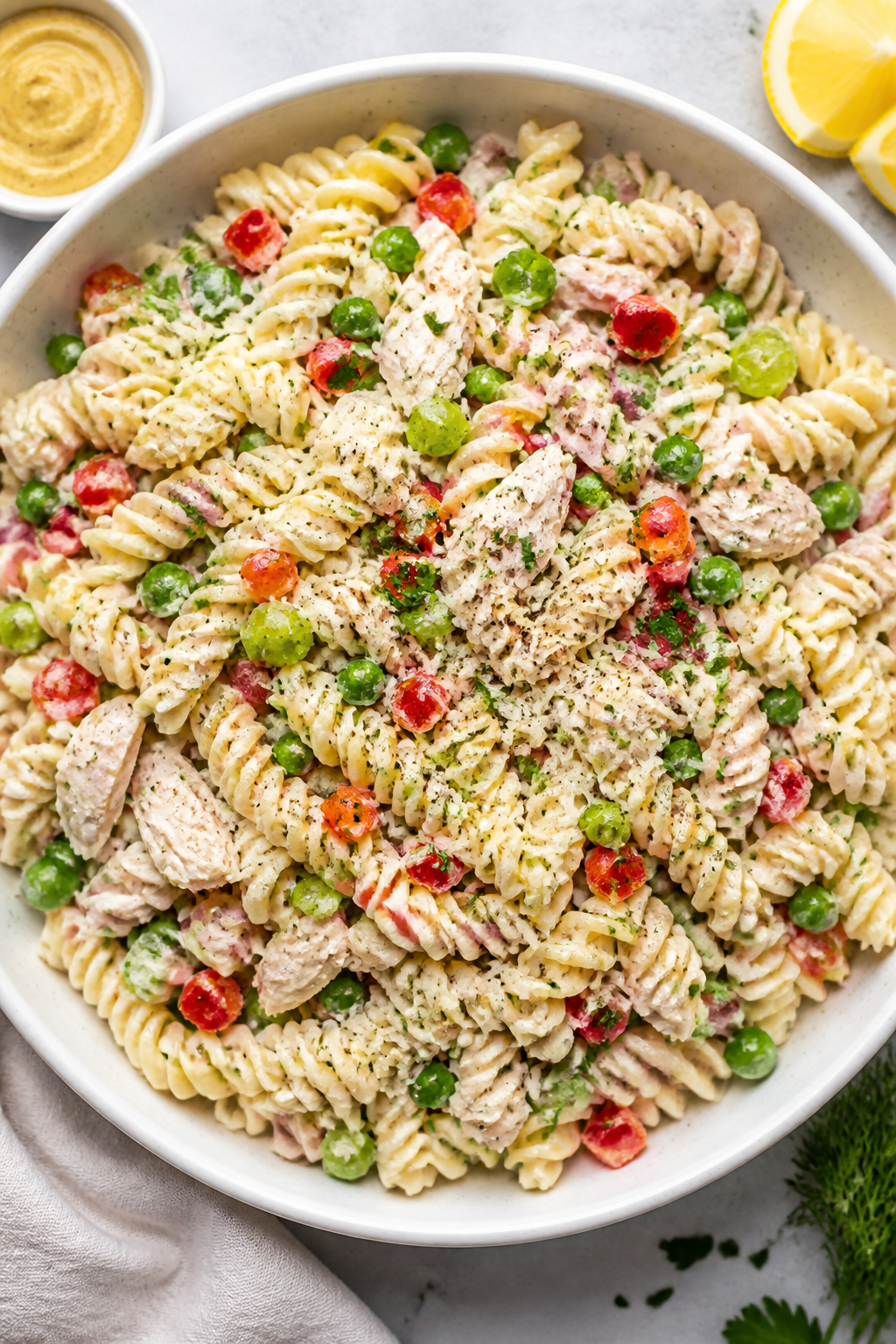 Tasty : Overhead shot of the finished Creamy Rotisserie Chicken Pasta Salad in a wide, shallow white