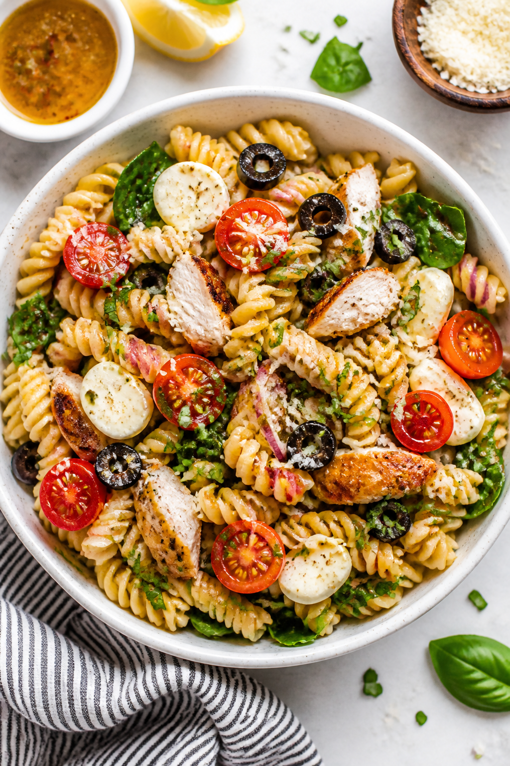 Tasty top view: Overhead shot of Chicken Parmesan Pasta Salad in a wide, white ceramic bowl—al den