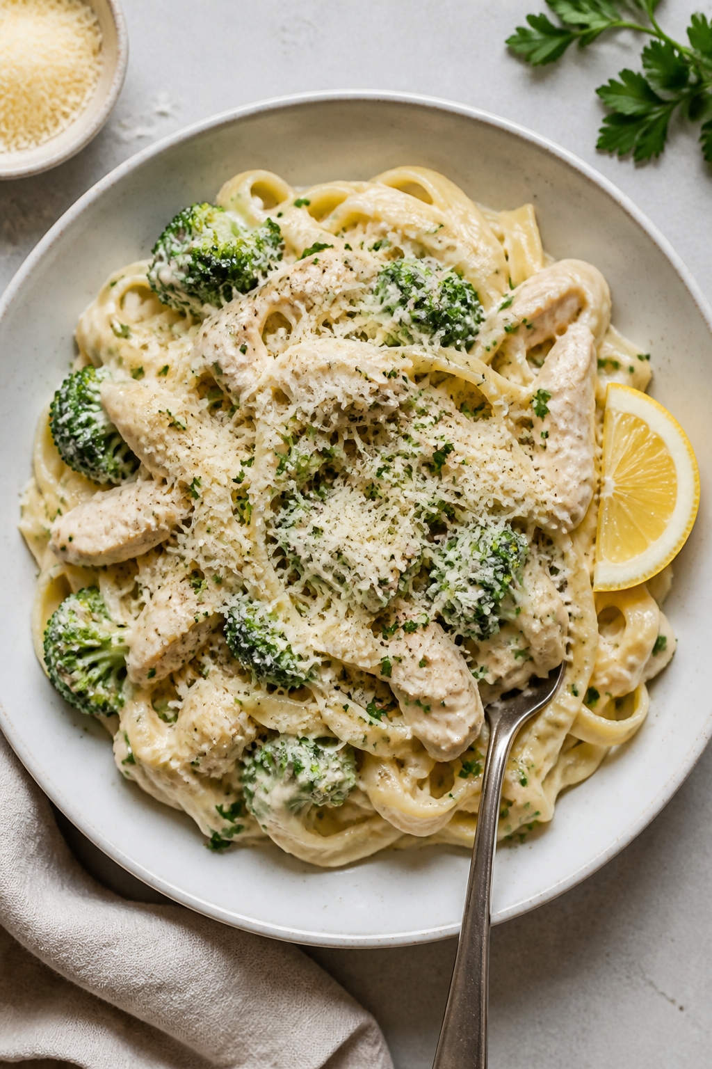 Tasty top view: Overhead shot of fettuccine tossed with creamy Crockpot Chicken Broccoli Alfredo in 