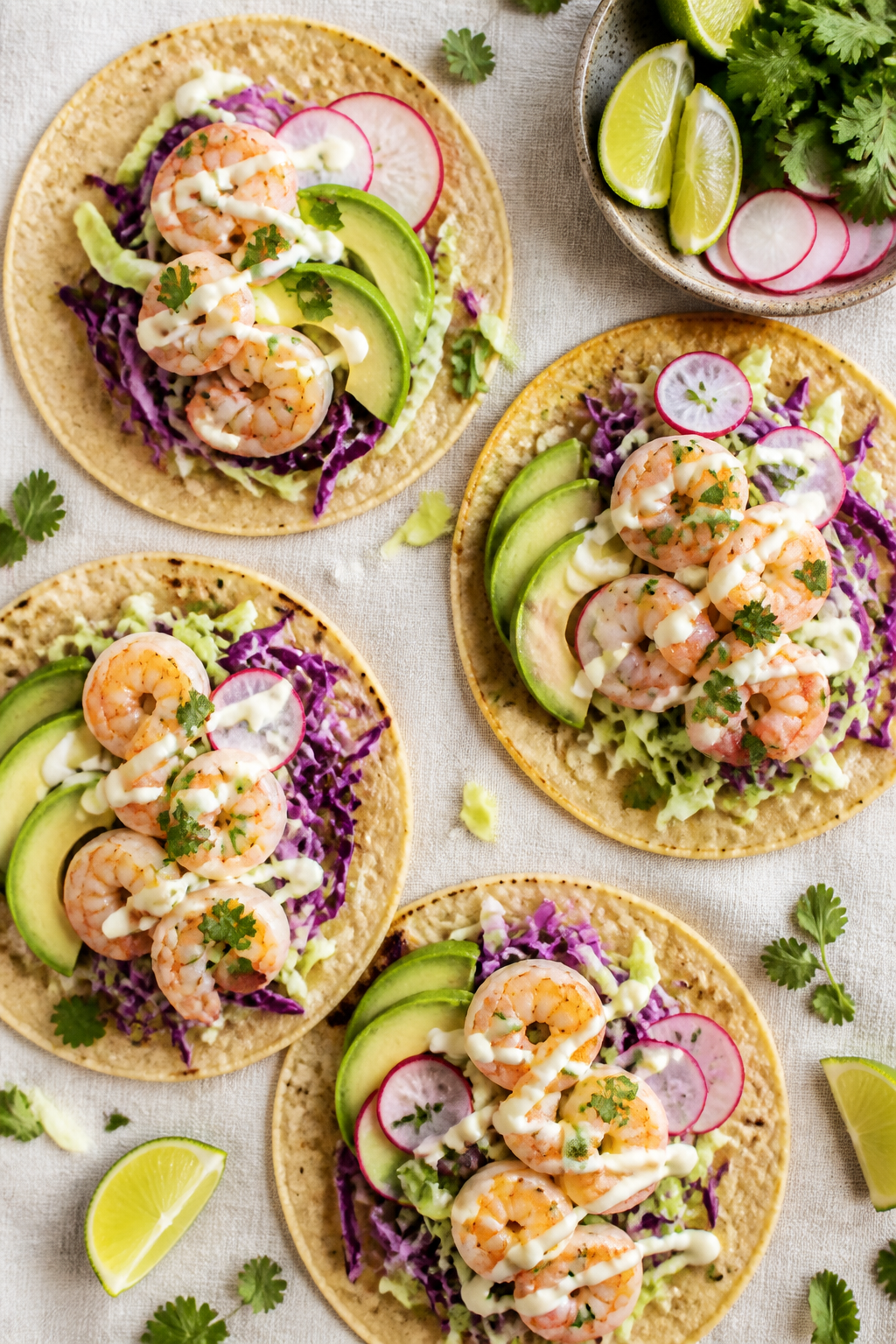 Tasty top view: Overhead shot of taco assembly—warm corn tortillas laid out with a base of lime-ci