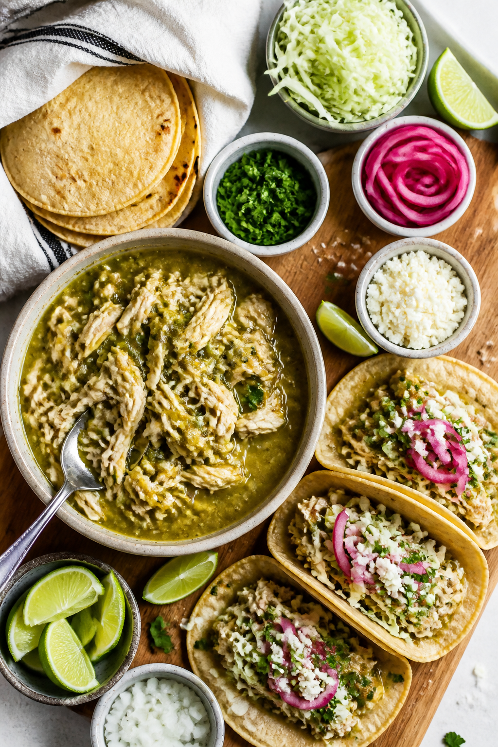 Tasty top-view spread: Overhead shot of a taco assembly board—stack of warm corn tortillas wrapped