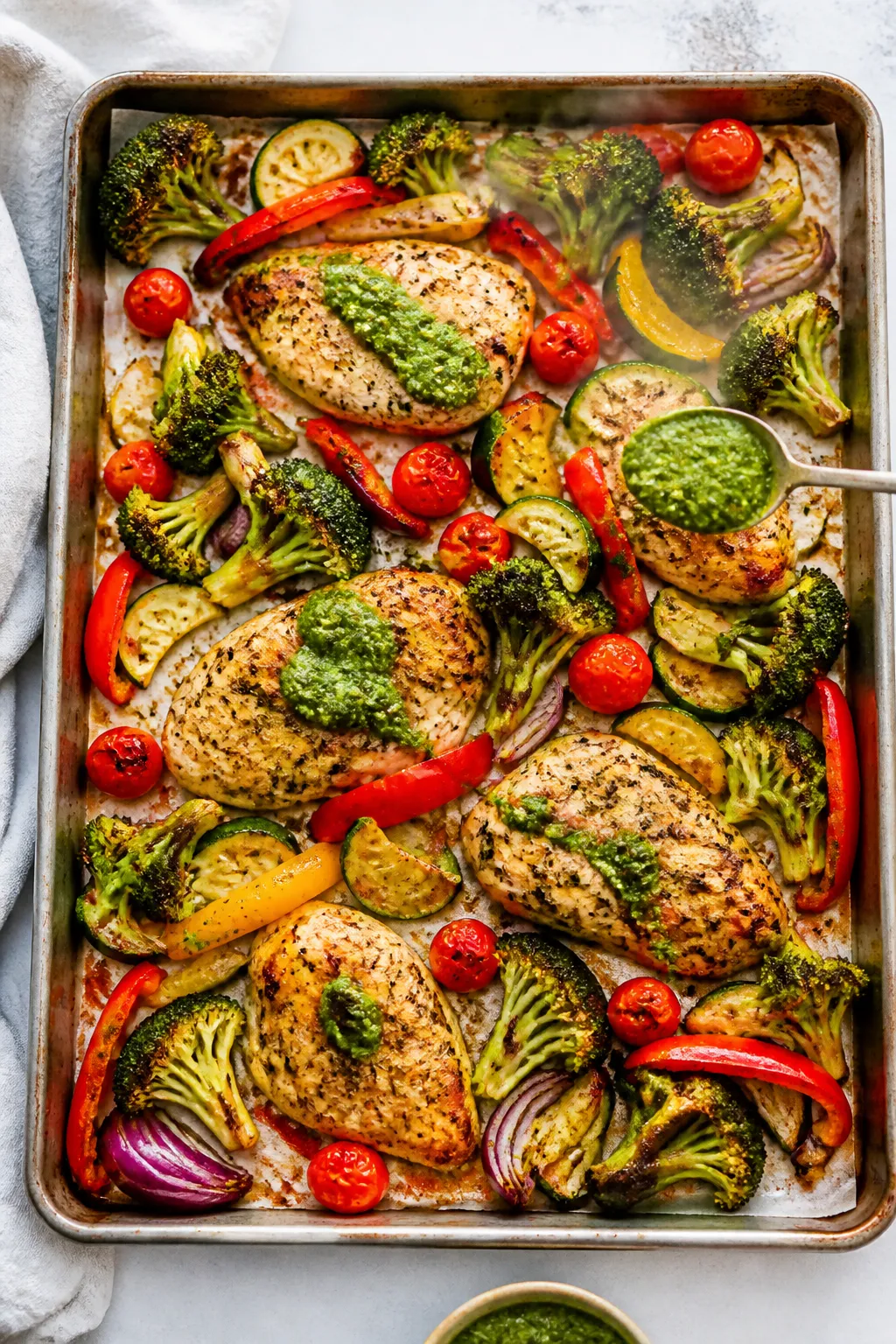 Cooking process, sheet-pan roast: Overhead shot of a hot sheet pan just pulled from a 425°F oven, s