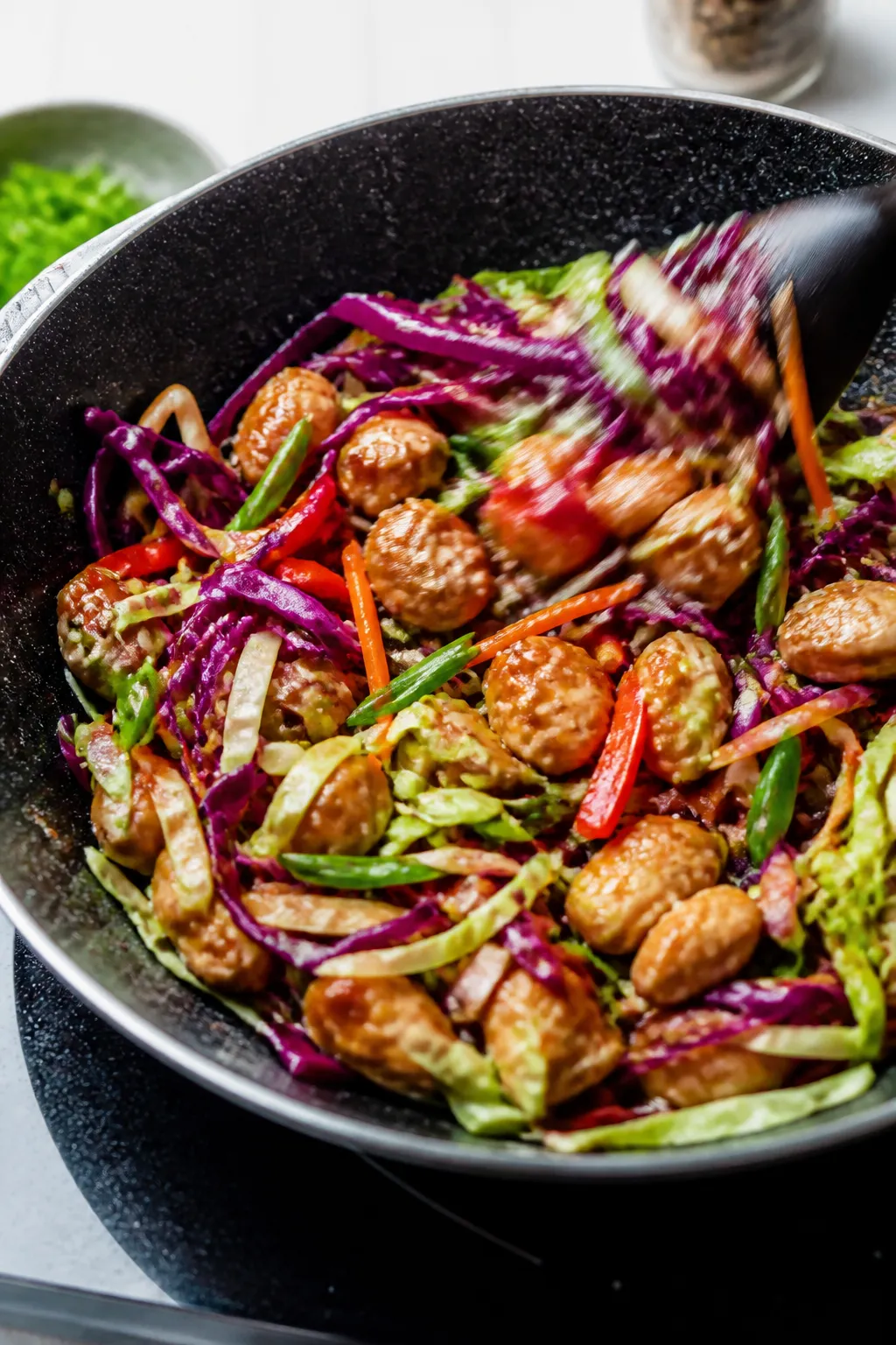 Cooking process: Stir-frying the colorful cabbage medley in the same skillet—green and red cabbage