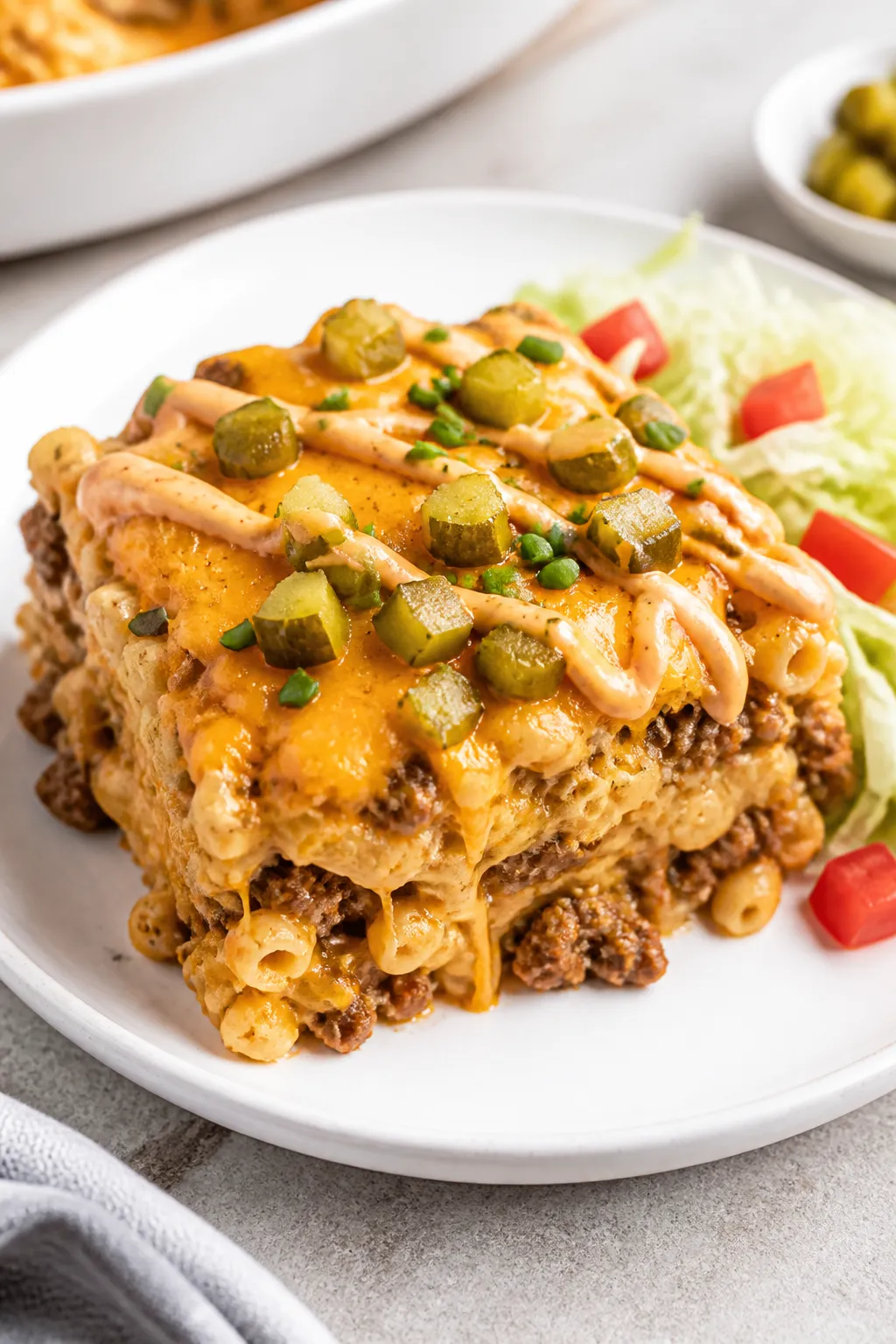 Final plated, cozy weeknight serving: A generous square of the casserole plated on a white ceramic d