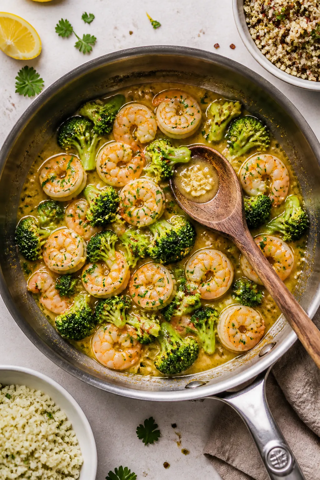 Tasty top view: Overhead shot of the finished skillet on a light stone surface, shrimp and broccoli 