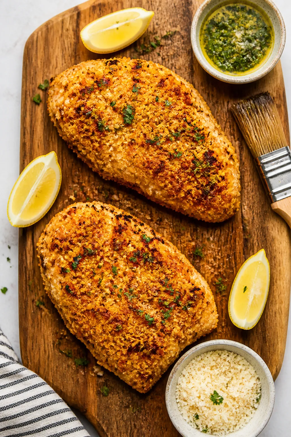 Tasty top view: Overhead shot of two garlic Parmesan chicken breasts arranged on a wooden board for 